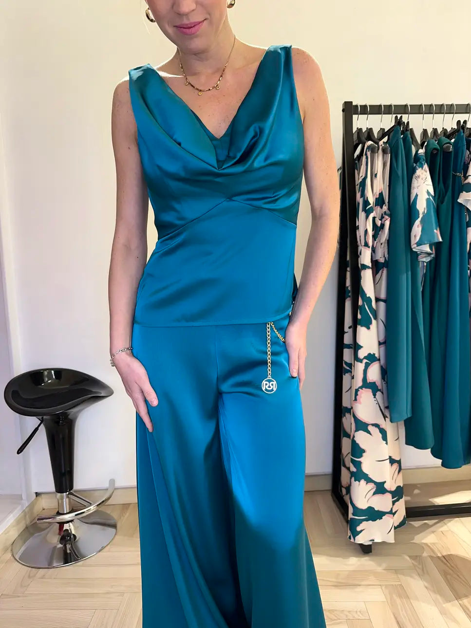 Completo elegante Claset con top satinato verde reale scollo morbido e pantalone a palazzo coordinato, indossato da modella in boutique