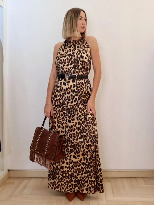 modella che indossa in negozio claset frirenze un abito animalier lungo abbinato con la borsa marrone a frange e borchie