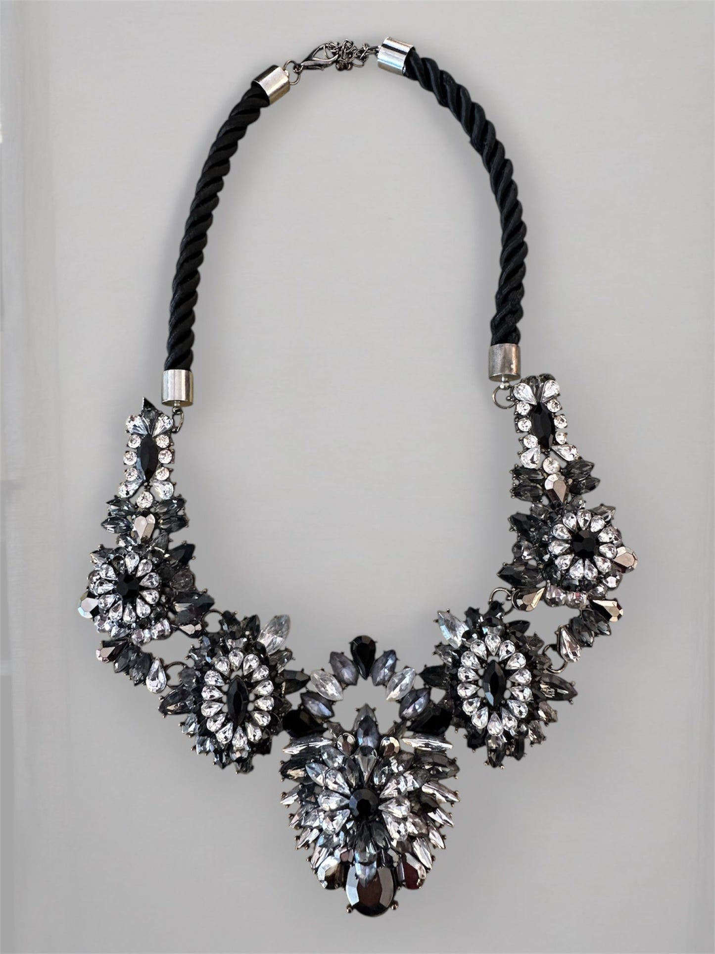 collana di Design artigianale con struttura rigida flessibile, Base in tessuto nero intrecciato, comoda da indossare, Ricamo centrale con pietre a specchio e cristalli sfaccettati,  Giochi di luce nero, argento e ghiaccio, Chiusura regolabile con gancio in metallo